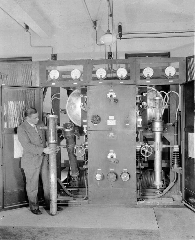 Operator inspecting a large RCA UV-862 power triode inside a GE/RCA 50B 50 kW broadcast transmitter, circa 1929